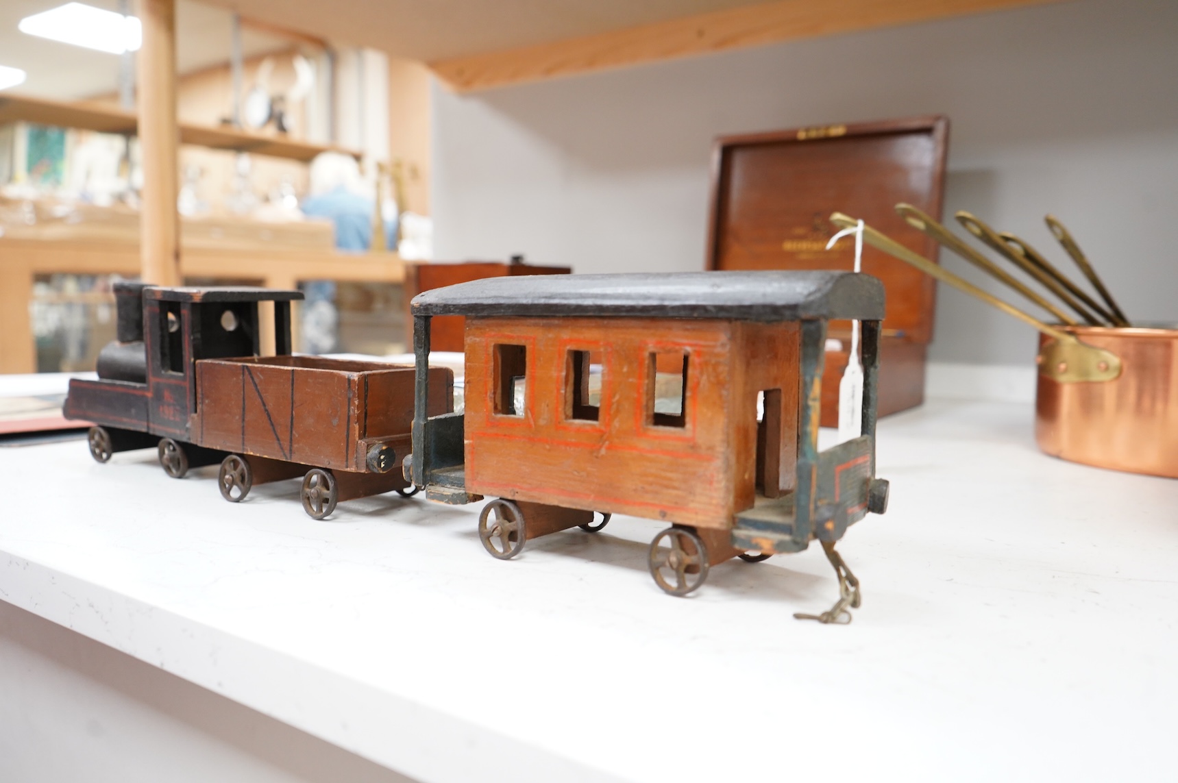 A painted wooden pull a long toy train-48cm long and two carriages, together with a painted wooden block puzzle